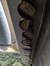 RV rental kitchen showing magnetic El Guapo spice tins (parsley, chili, coriander, paprika) for organized cooking on the go.