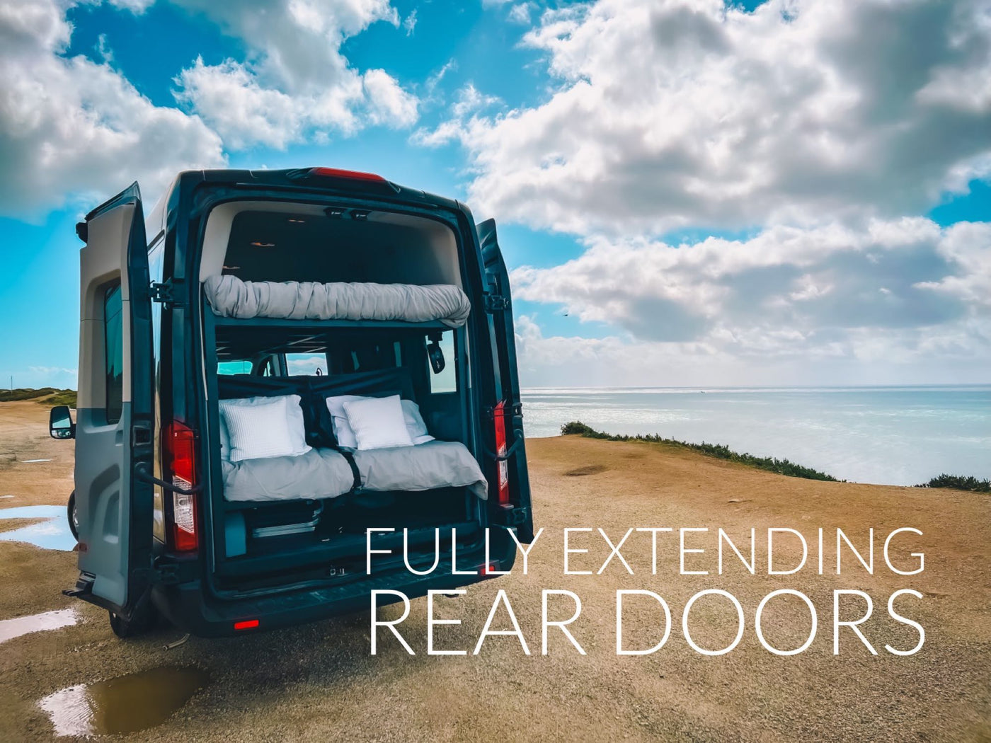  & an open door revealing a stunning ocean view.|Cozy rv rental interior with a comfy bed — photo 4