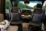 View from inside this spacious RV rental, highlighting the comfortable front seats, dashboard, and scenic outdoors.