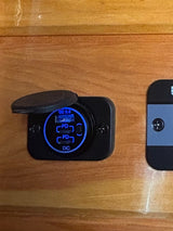 An RV rental charging station featuring blue-lit QC 3.0 USB and dual PD USB-C ports, embedded in wood for convenient power access.