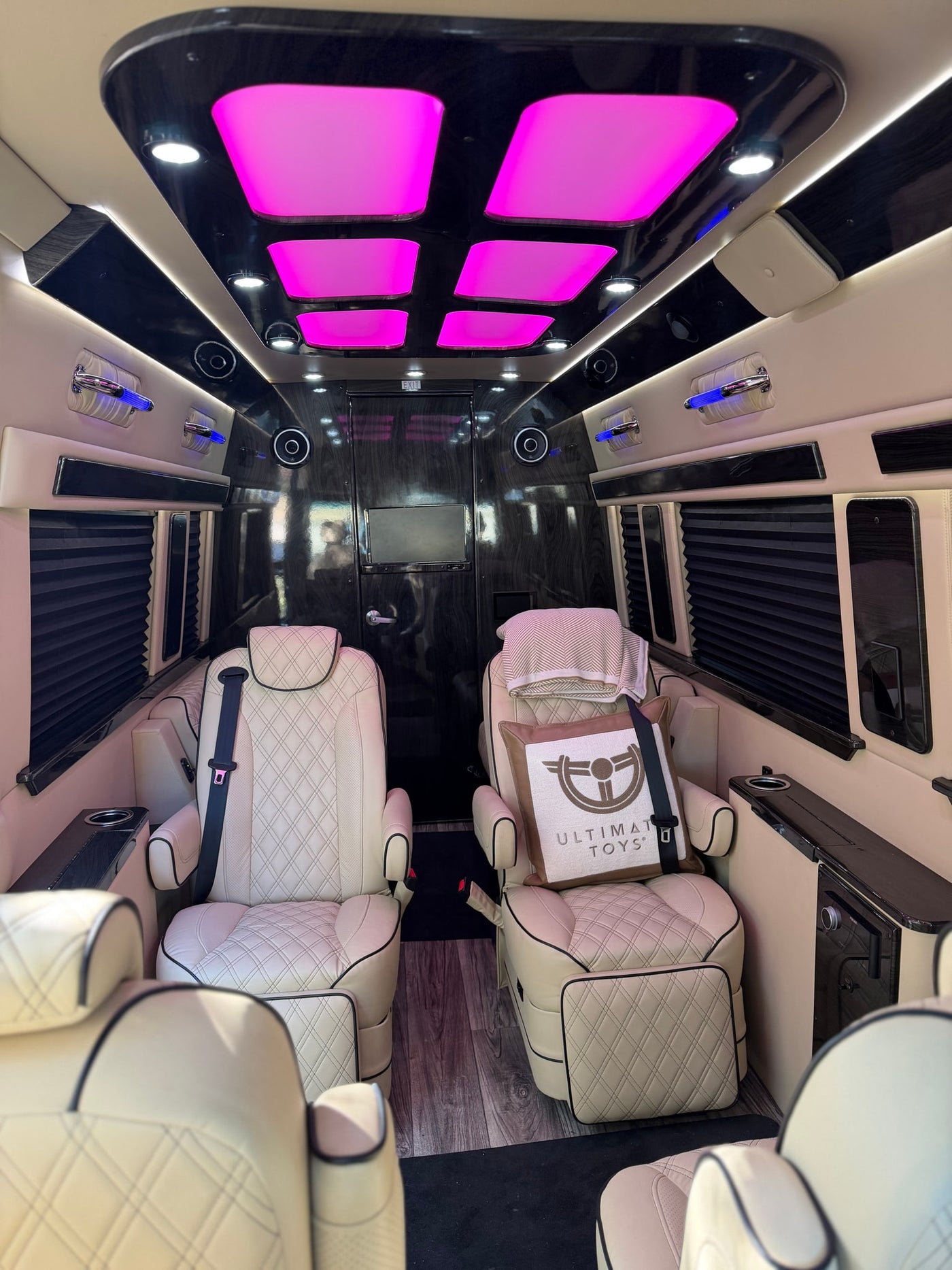 Luxury RV rental interior featuring plush seating, vibrant LED lights, and custom finishes for premium travel. — photo 11