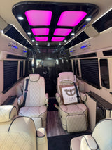 Luxury RV rental interior featuring plush seating, vibrant LED lights, and custom finishes for premium travel.