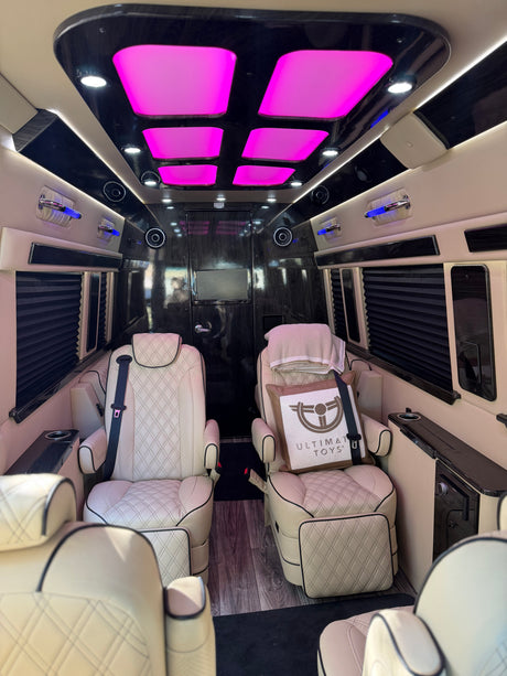Luxury RV rental interior featuring plush seating, vibrant LED lights, and custom finishes for premium travel.