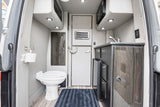 Discover comfort in an rv rental: functional interior with a toilet, compact kitchen sink, microwave, and smart storage.