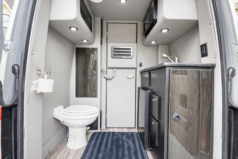  and smart controls offer ultimate travel comfort.|Spacious luxury rv rental interior with quilted seating — photo 10