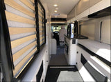 Inside this RV rental: modern galley kitchen, convertible bed system, and bench seating. Compact and efficient interior design.