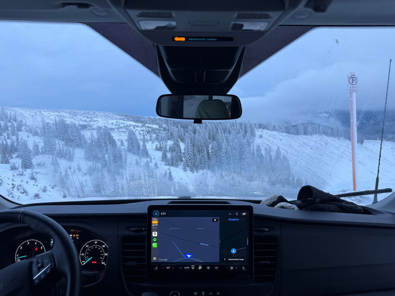 Snowy mountain view from an RV rental's dashboard, with navigation set to Government Camp. A winter road trip adventure. — photo 17