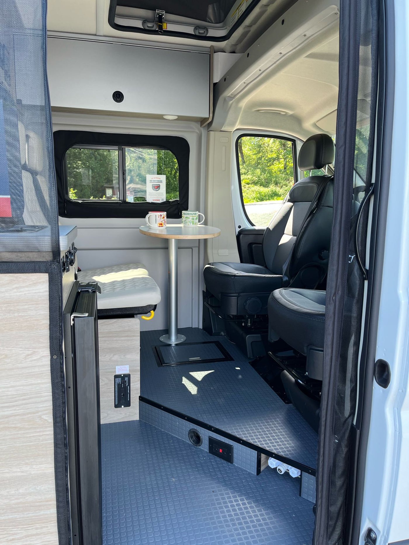  revealing a dog inside and camping gear beside it.|Your next RV rental: a modern camper van interior with a dinette — photo 5