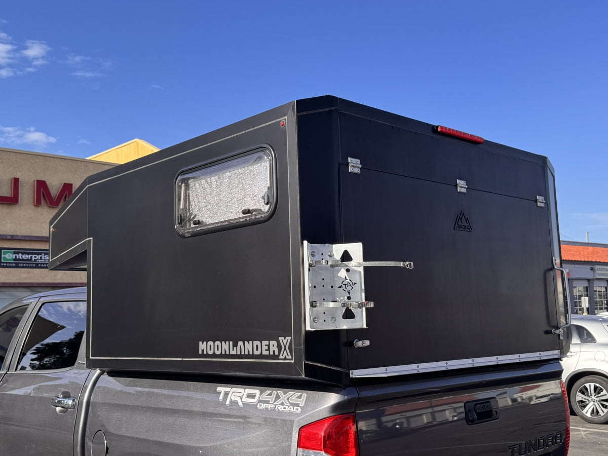 Rear three-quarter view of the Moonlander X camper showing the MOONLANDER X badge, side window and rear access panel — photo 2