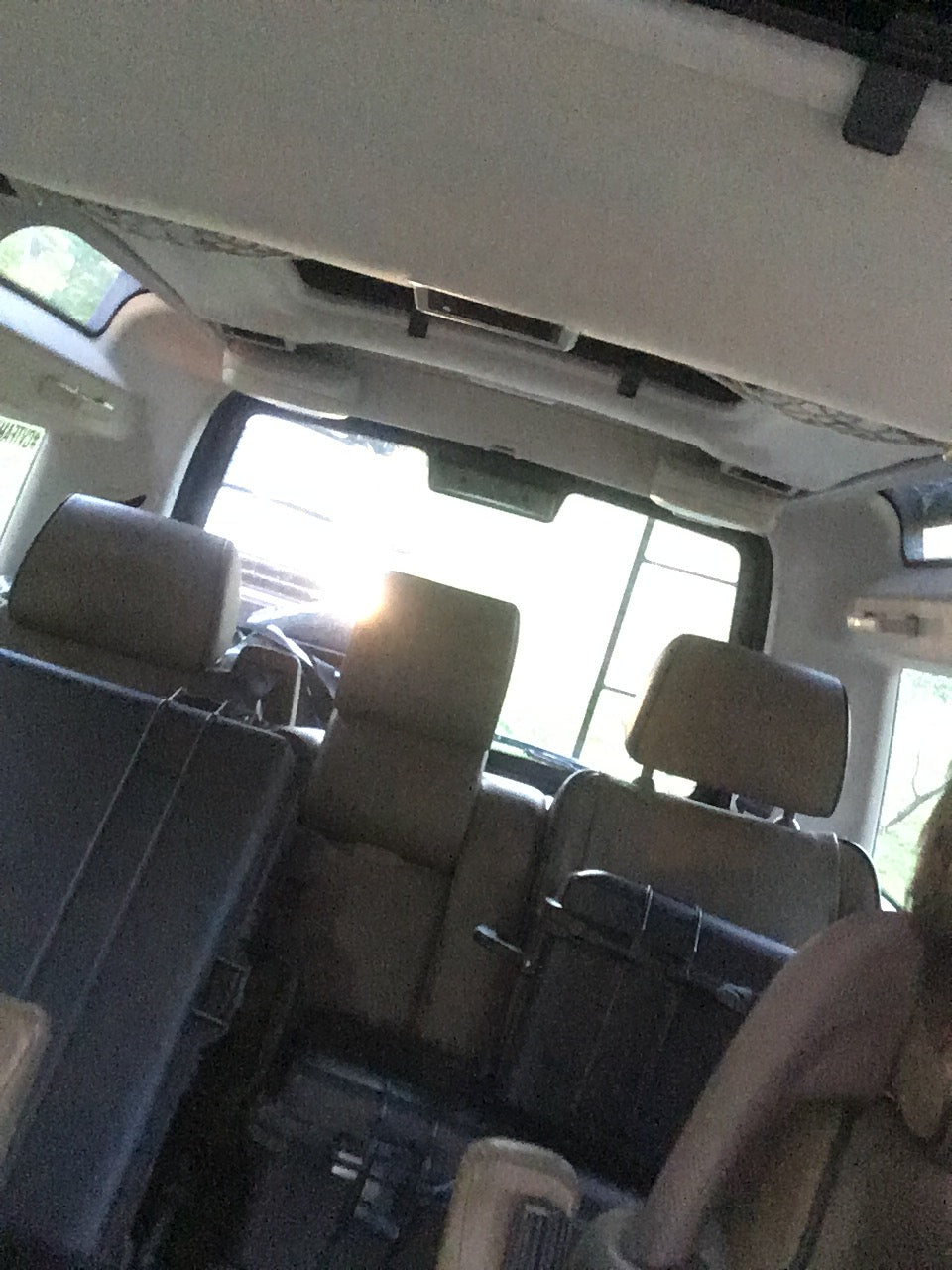 Interior view of a spacious RV rental, showing multiple rows of passenger seats for comfortable travel.
