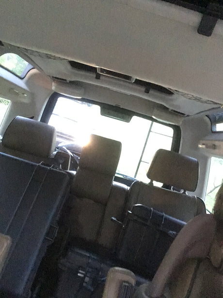 Interior view of a spacious RV rental, showing multiple rows of passenger seats for comfortable travel.