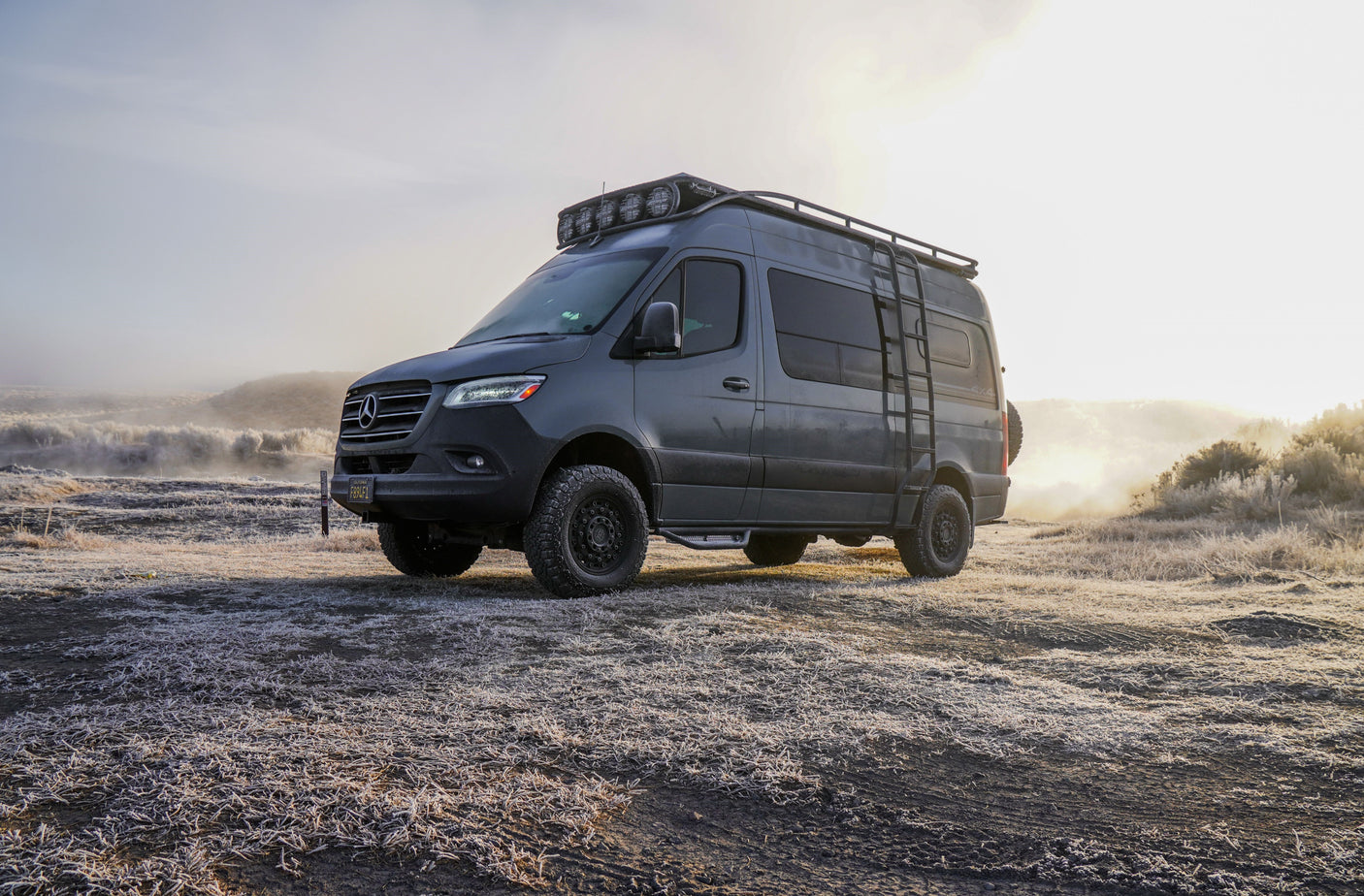 Off-road Mercedes Sprinter camper van on a frosty morning. Ideal RV rental for exploring wintery landscapes.
