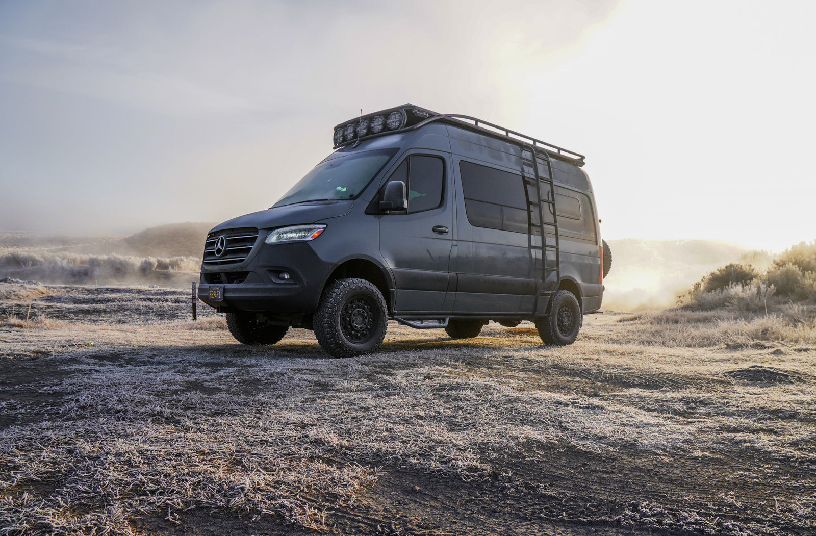 Off-road Mercedes Sprinter camper van on a frosty morning. Ideal RV rental for exploring wintery landscapes.