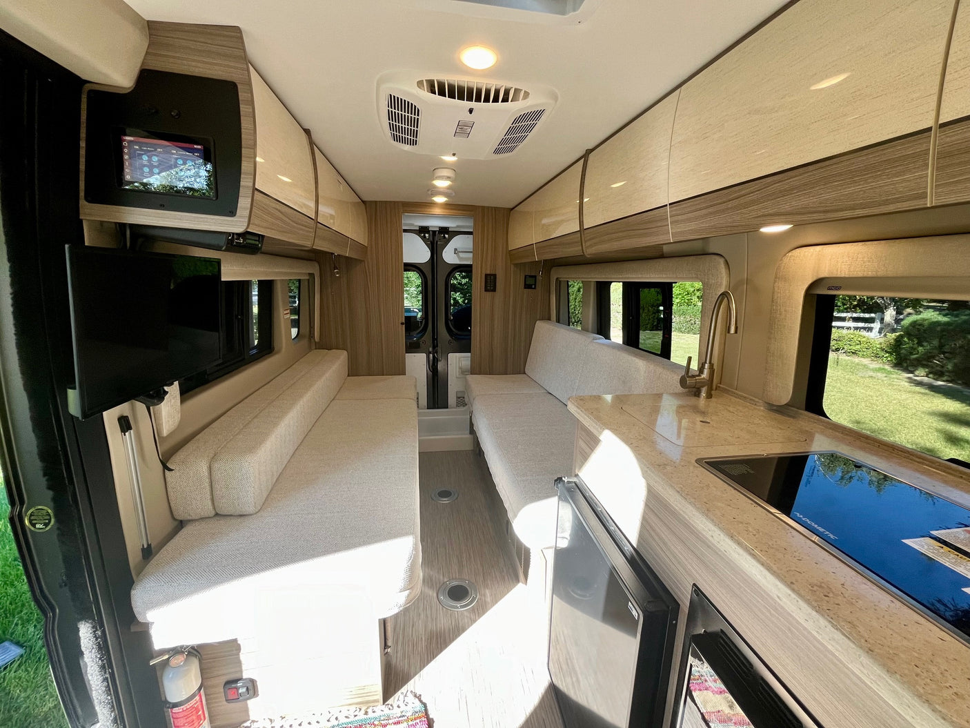 Spacious RV rental interior with modern kitchen, comfortable seating, and essential amenities for travel.
