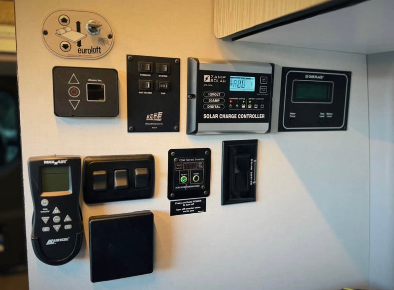 This RV rental's central control panel features solar charge, bed lift, climate, and system monitors for comfortable travel. — photo 14
