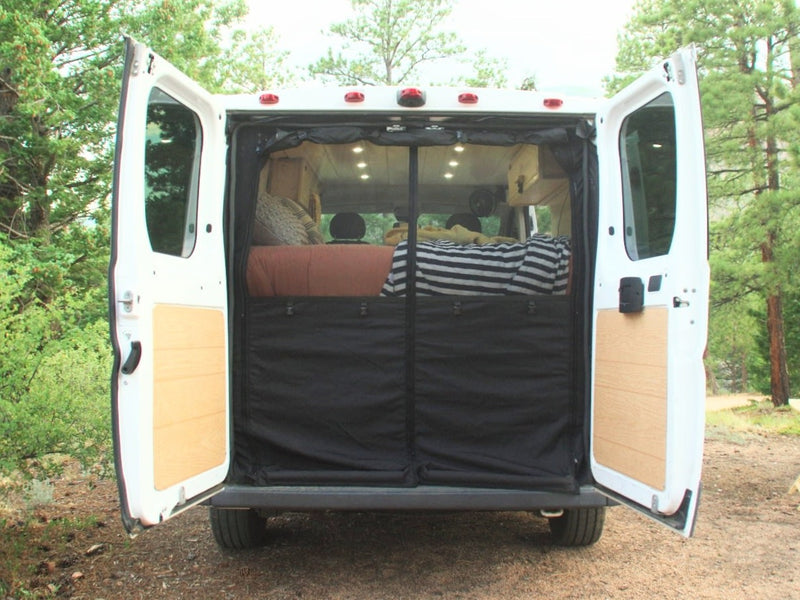 and a Jeep visible outside.|Cozy RV rental view from inside: tall pine trees — photo 13