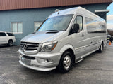 This silver Airstream Mercedes-Benz Sprinter Class B RV, parked outdoors, is ready for your next rv rental adventure.