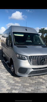 Experience travel in style: a silver Mercedes-Benz Sprinter van with custom grill, perfect for an RV rental adventure.