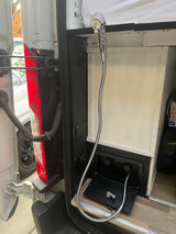 RV rental van's rear: Chrome pull-out shower head, hose, and water mixer panel for convenient outdoor use.