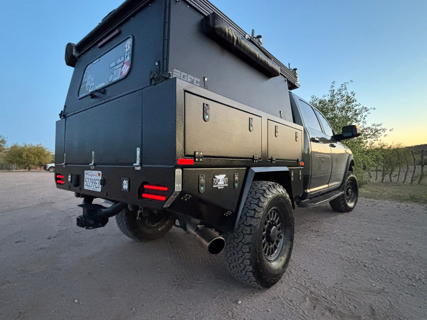 is ready for adventure.|Explore with this robust RV rental: a dark green truck outfitted with an EGFC overlanding camper and an Overland Pros awning.|This rugged — photo 3