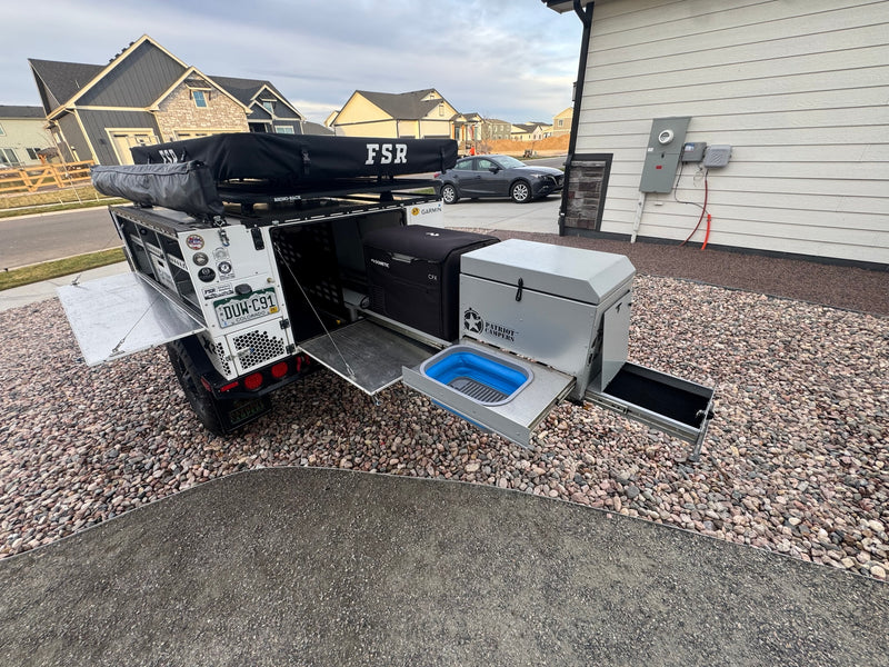 This overland camping trailer, ready for adventure via rv rental, features a rooftop tent, Dometic fridge, and pull-out kitchen. — photo 14