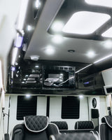 Luxurious RV rental interior: microwave, quilted seating, and sleek LED lighting for your comfort.