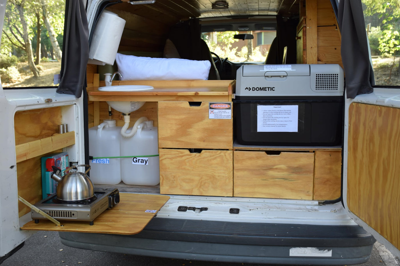  and warm wood finishes.|Cozy RV rental interior with a bed — photo 13