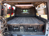 Overland-ready RV rental setup: Truck bed with DECKED drawers, Rebel Off Road rack, fire extinguisher, and propane tank.