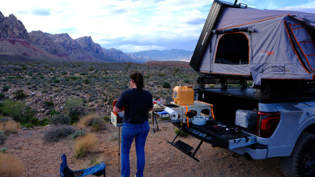 Cooking outdoors from a truck with a rooftop tent. An ideal rv rental for desert overlanding & mountain views.