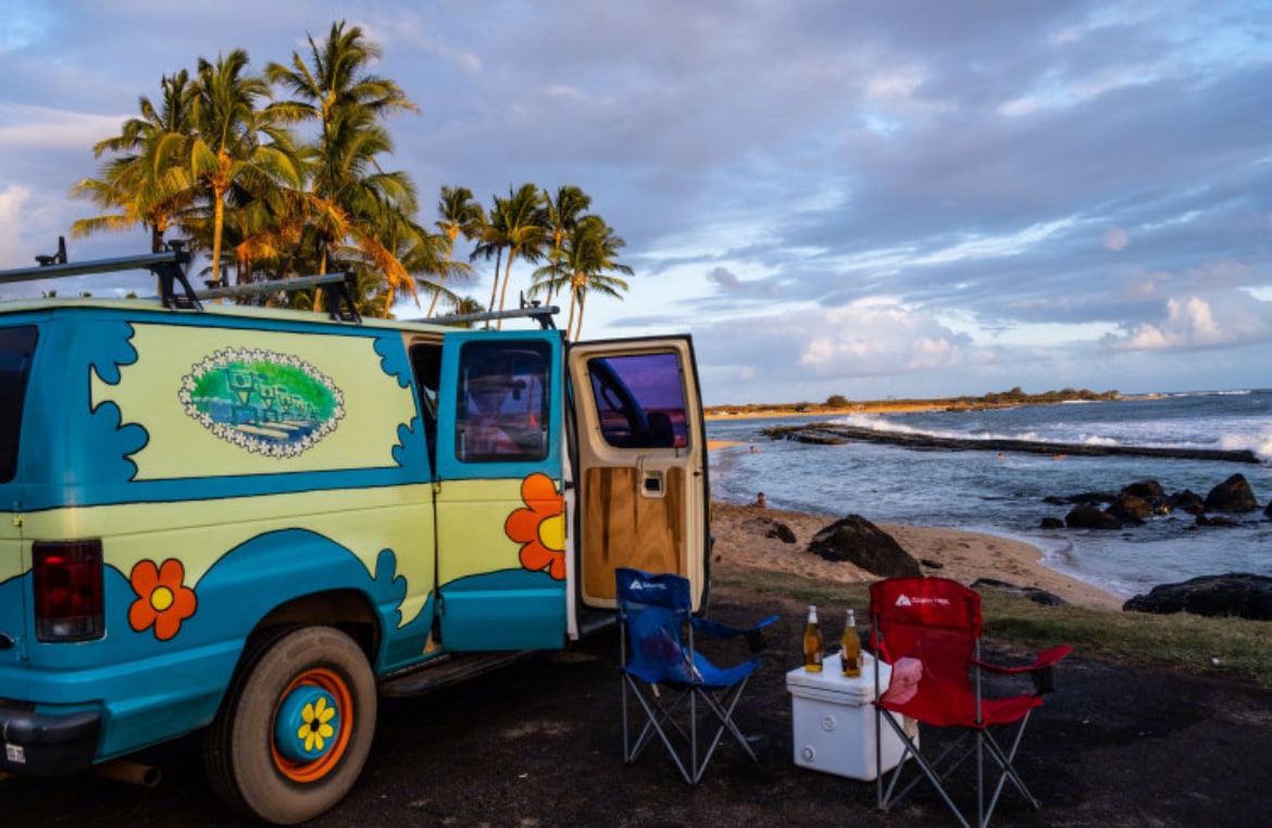  and colorful rugs. Ready for van life adventures.|Step into this colorful RV rental: a plush bed — photo 13