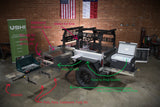 This RV rental-ready off-road trailer features a full pull-out camping kitchen with stove, fridge, and ample storage.