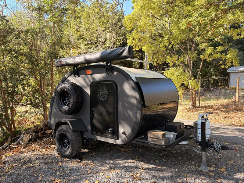 2022 Bean Meaner Bean teardrop camper, dark grey, front three-quarter exterior with roof rack and spare tire — photo 1