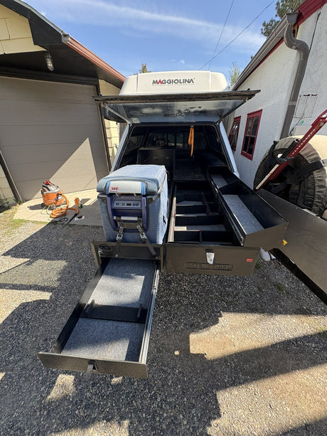 Extendobed truck bed drawer system fully extended out of a Toyota Tundra bed, with the main drawer, lower slide-out tray and the ARB fridge on its slide