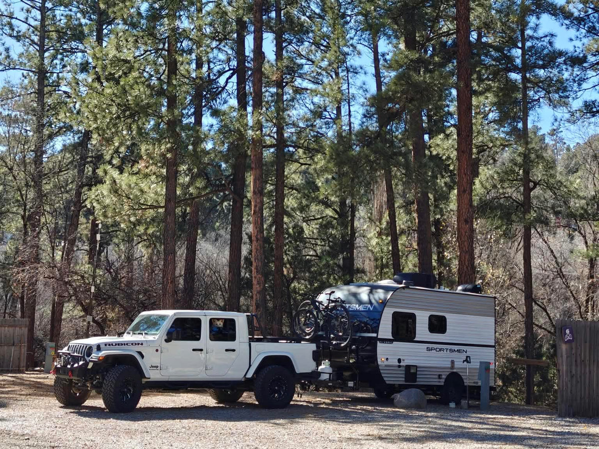  parked among tall pines. Perfect for a camping adventure.|RV rental: Sportsmen Classic trailer — photo 6