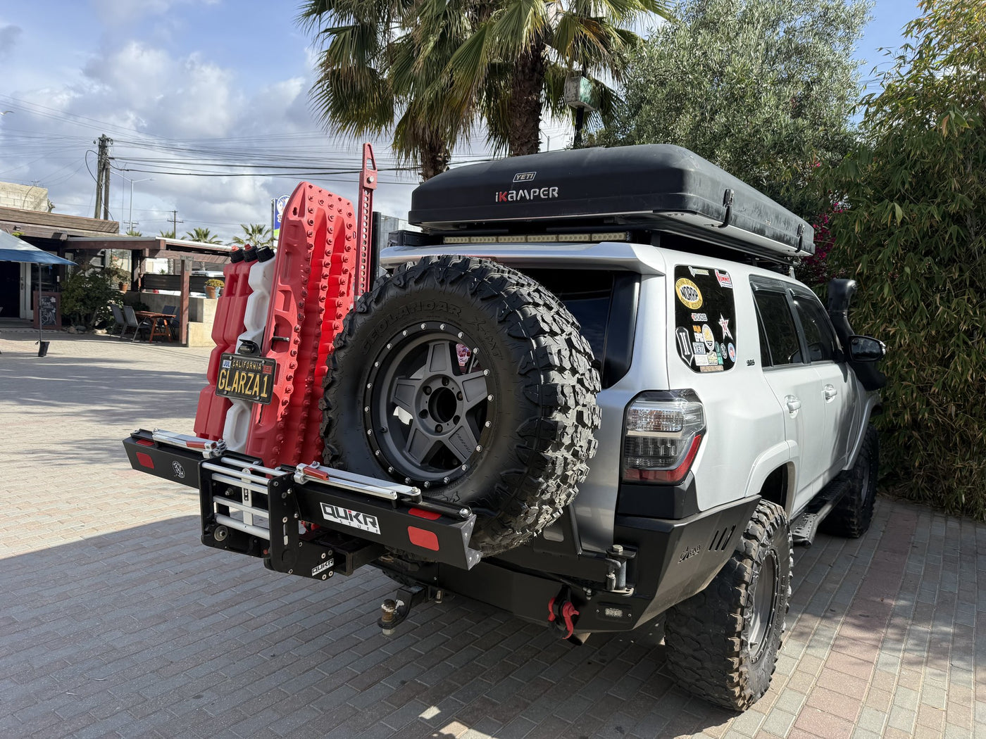 iKamper rooftop tent and MaxTrax recovery boards mounted on the rear carrier — photo 6