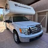  perfect for an RV rental outdoor adventure.|White Ford F-150 pickup with Adventurer truck camper