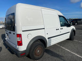 White Ford Transit Connect cargo van, often used for compact **RV rental** conversions, parked on asphalt.