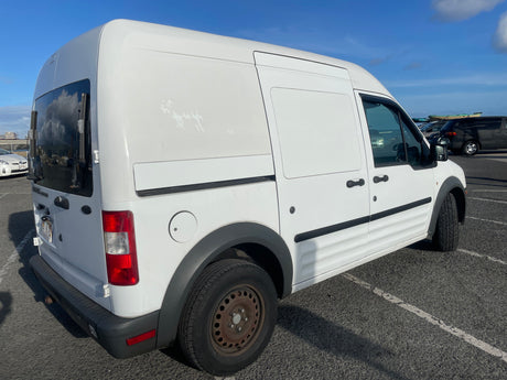 White Ford Transit Connect cargo van, often used for compact **RV rental** conversions, parked on asphalt.