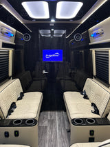 Experience comfort in this luxury **rv rental** featuring plush white seats, ambient lighting, and a Supersonic TV.