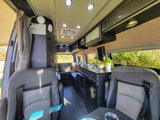 Inside a sleek rv rental: enjoy the equipped kitchen, comfy seating, and ample space of this modern camper van.