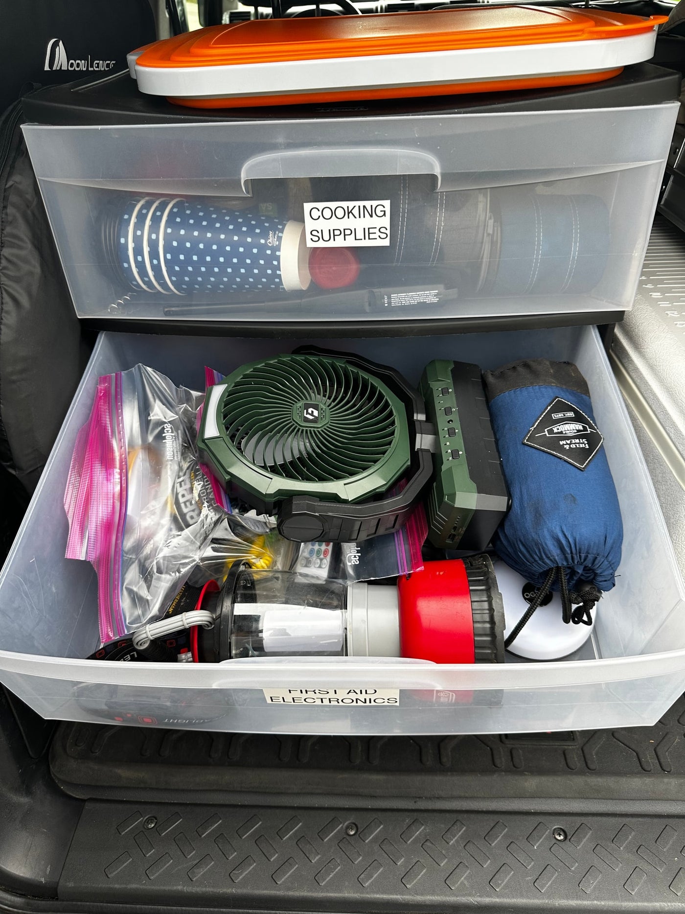 Organized RV rental storage drawers: cooking supplies on top, electronics & first aid below, for well-prepared camping trips. — photo 17