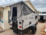 This Coachmen Clipper pop-up rv rental, an outdoor camping trailer, is ready for adventure with its canvas top extended.