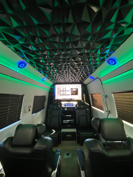 Experience our luxury rv rental! Featuring a modern geometric ceiling, vibrant LED lighting, plush seating, and a large sports display.