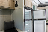 Empty fridge & freezer inside an RV rental, ready for your provisions. Features cabinets & control panel for an adventure.