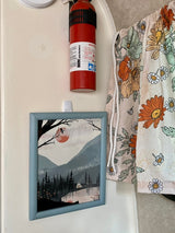 RV rental interior featuring a fire extinguisher, framed art, and floral fabric for safety and cozy decor.