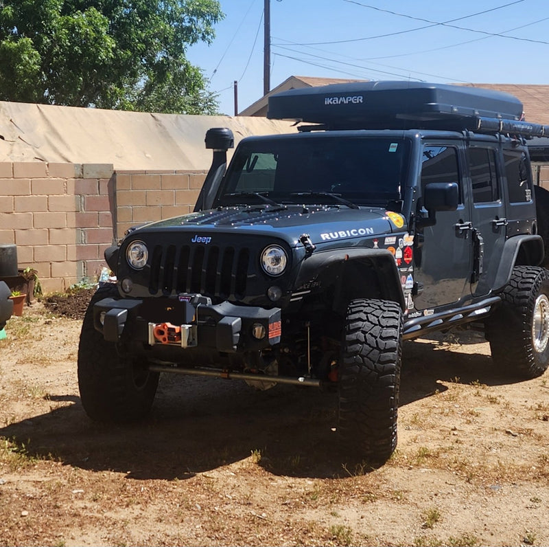 iKamper Skycamp 3.0 closed in travel mode on the roof rack, showing the black hardshell and iKamper badge — photo 5