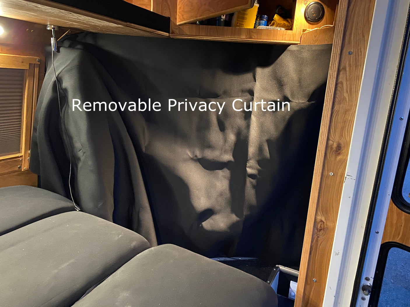 RV rental: A practical black removable privacy curtain offers enhanced comfort and adaptable space in the vehicle's interior.