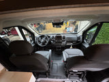 Front cabin view of an RV rental van, showing the dashboard, steering wheel, and comfortable seats. Ideal for road trips!