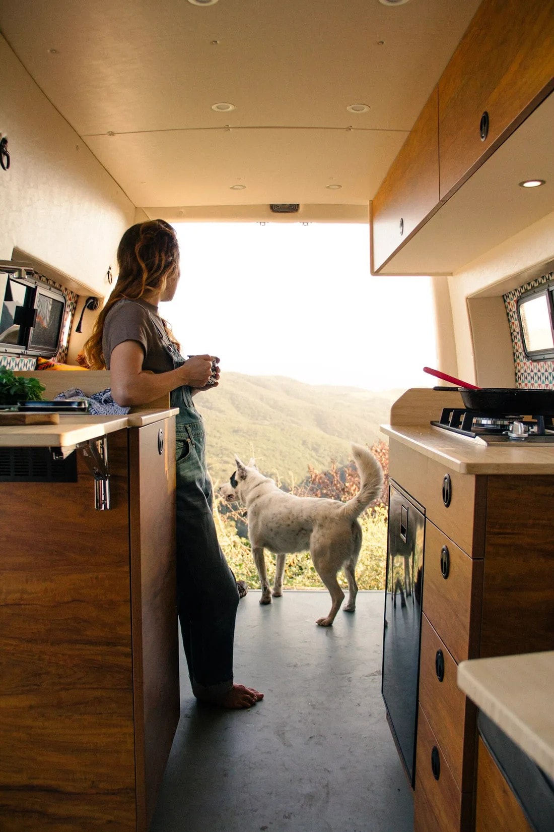  and a bright window.|Colorful pillow on cozy bed inside an RV rental — photo 6