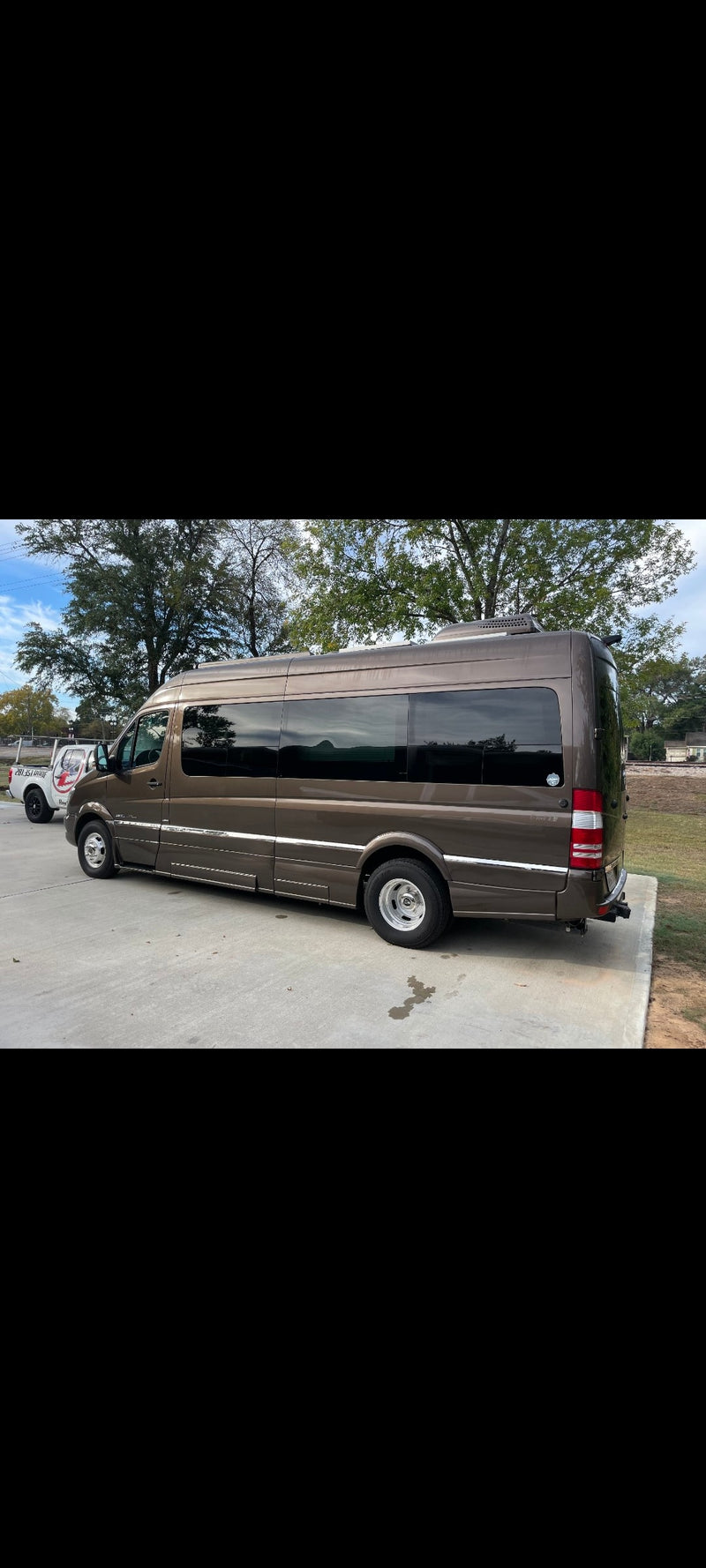 Sleek brown Mercedes Sprinter conversion van, perfect for rv rental, parked on concrete. — photo 1